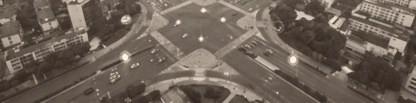 An aerial view of a city interchange with connected nodes overlaid, representing sites linked into one platform.